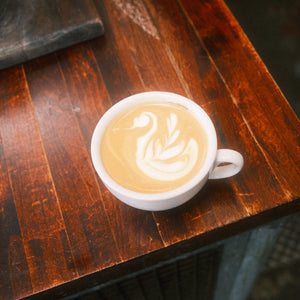 Cappuccino with latte art on a wooden table