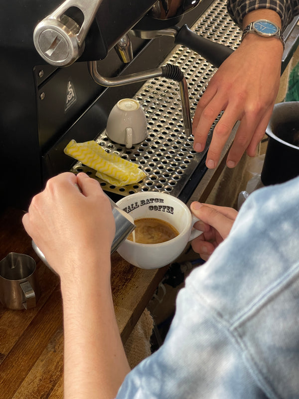 Hands Pouring Coffee in Cafe - Small Batch