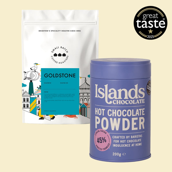 Coffee package and Islands Chocolate hot chocolate powder can on a beige background with Great Taste award logo.
