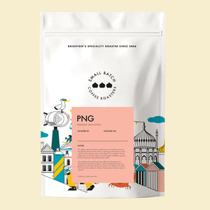 small batch Coffee papua new guinea paradise mountain coffee bag with colorful design and text on a beige background