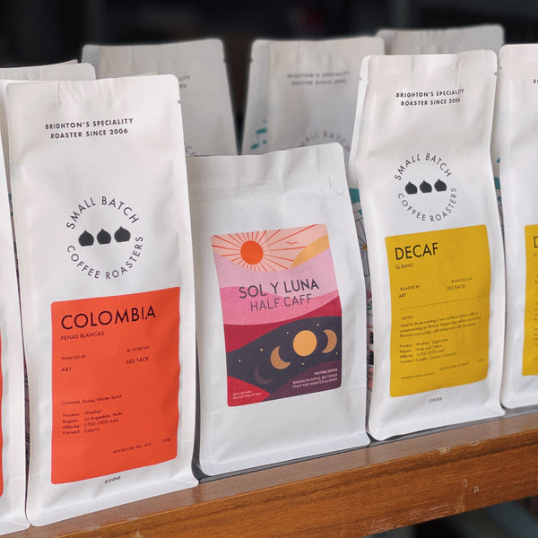 Assorted coffee bean packages on a shelf with visible branding.