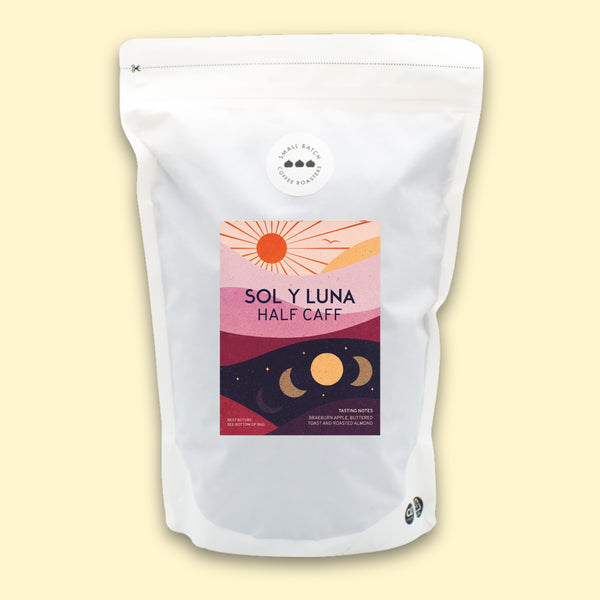 White coffee bag with 'Sol y Luna Half Caff' label on a light yellow background