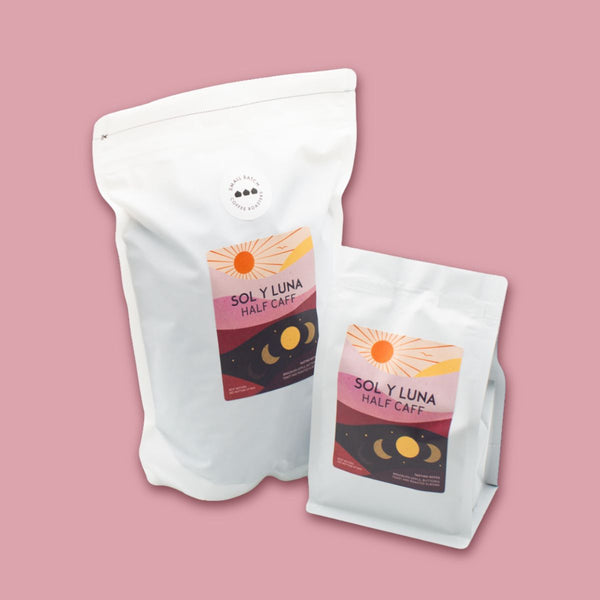 Two Sol y Luna coffee bags on a pink background